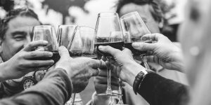 people cheering with wine glasses