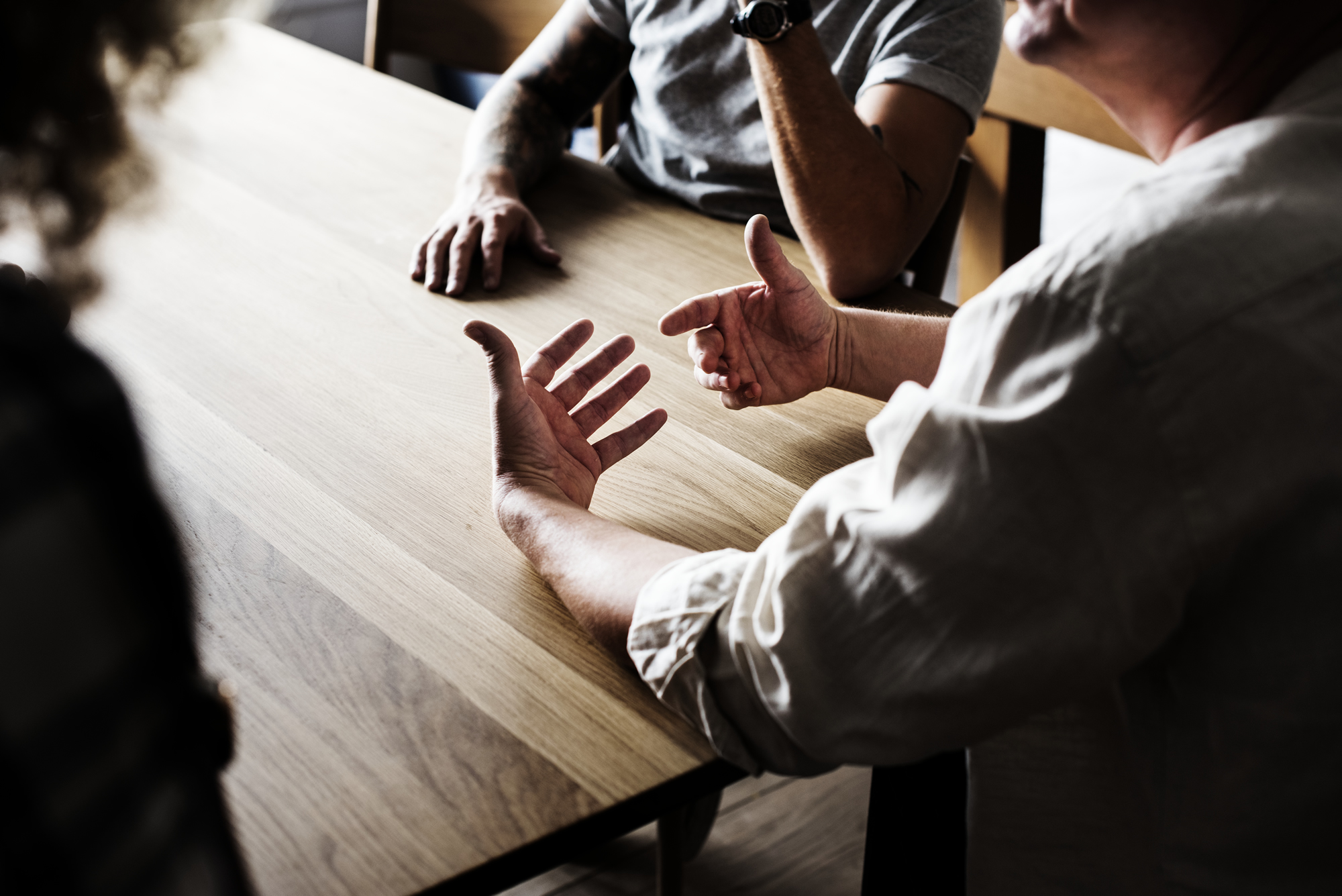 Friends around a table talking