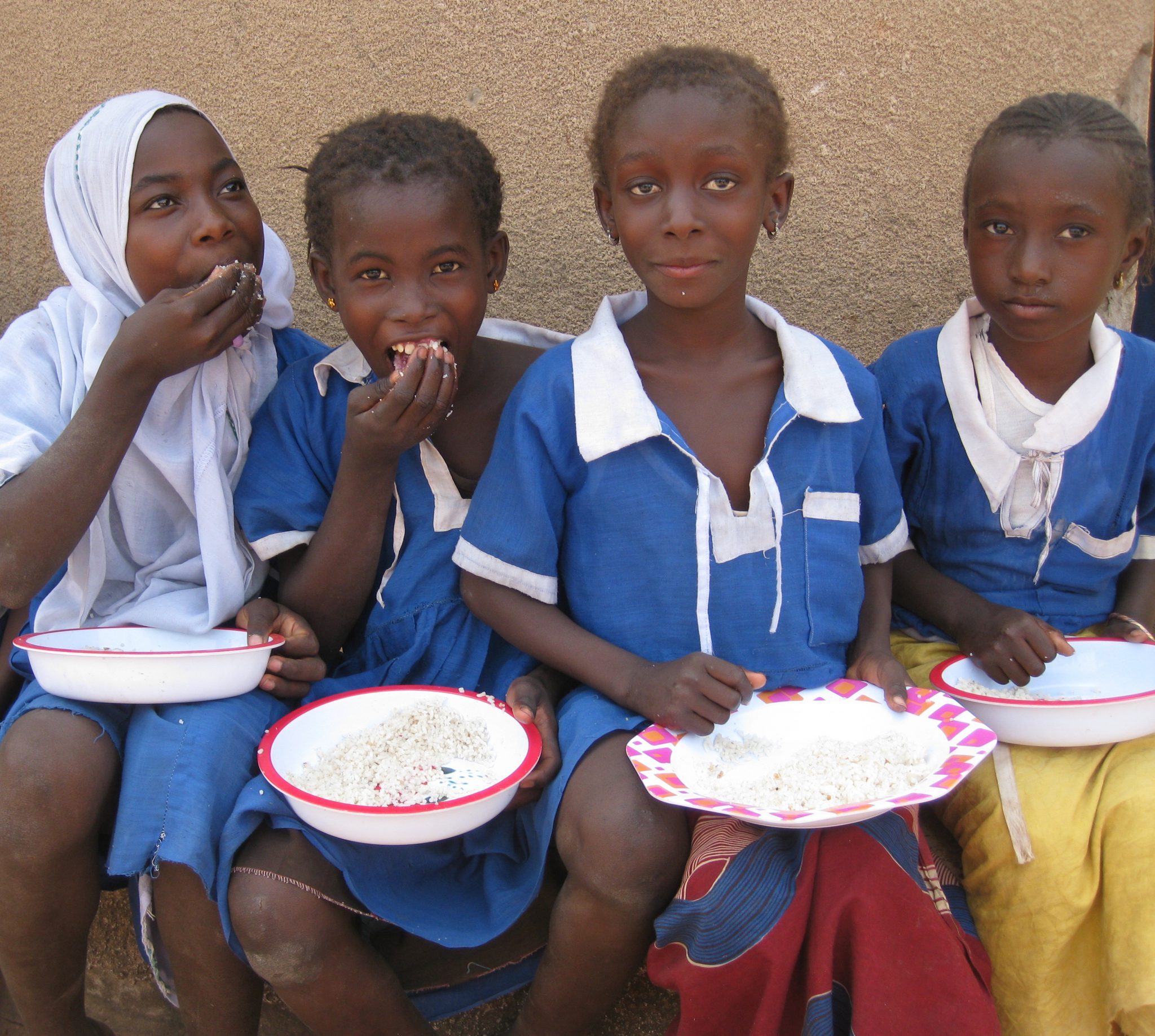Four children eating a school meal
