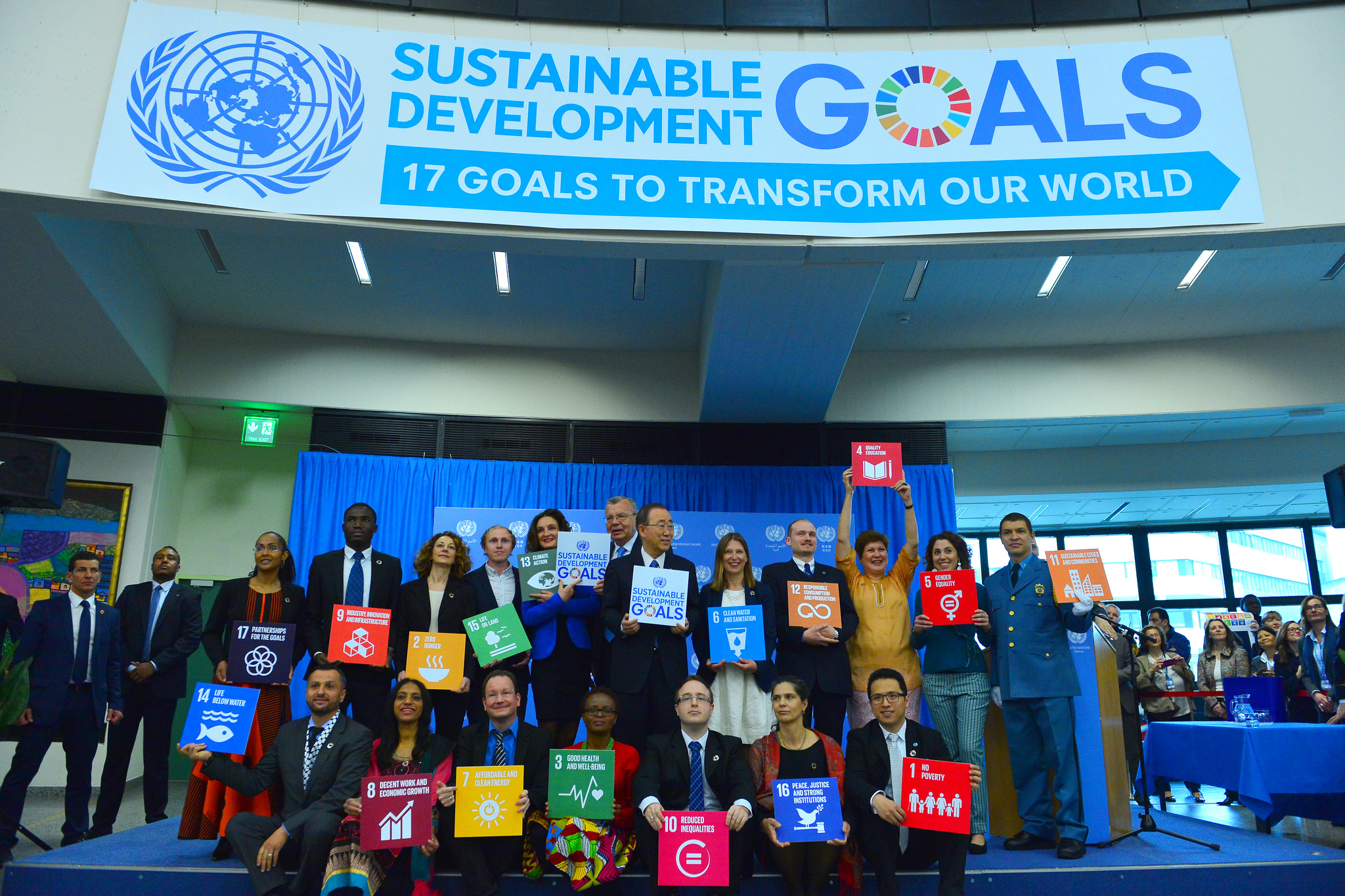 United Nations Secretary-General Ban Ki-moon and seventeen staff each hold a card for one of the Sustainable Development Goals