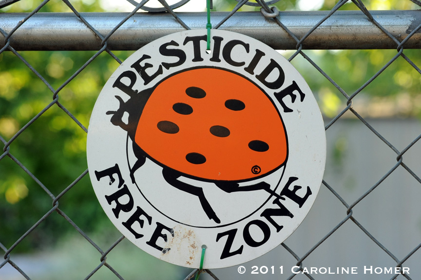 Pesticide free zone sign on a fence