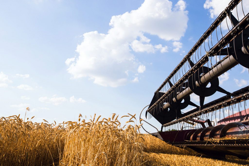 Photo of combine harvester that is harvesting wheat