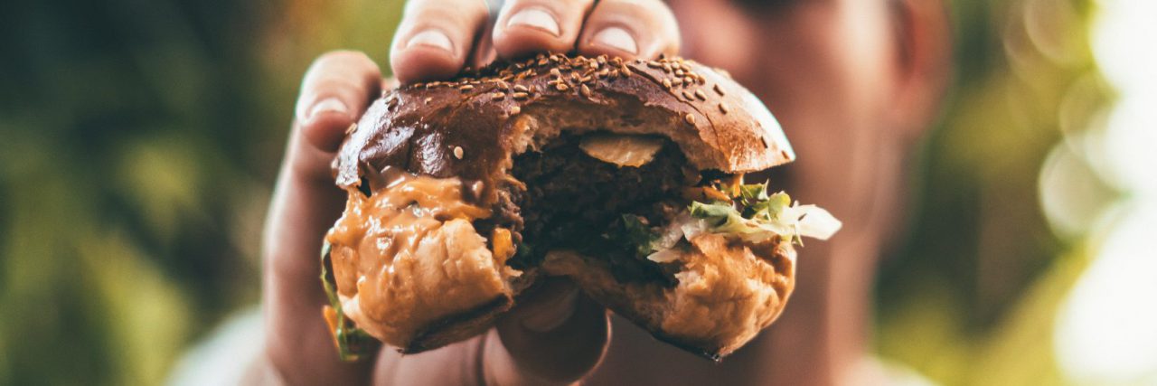 A man holding a burger