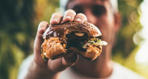 A man holding a burger